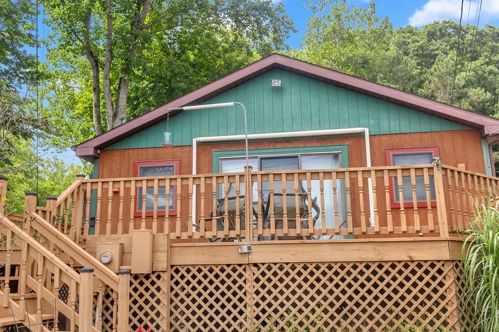 Lake cabin with a wraparound deck at 7669 N John Young Rd on Lake Lemon